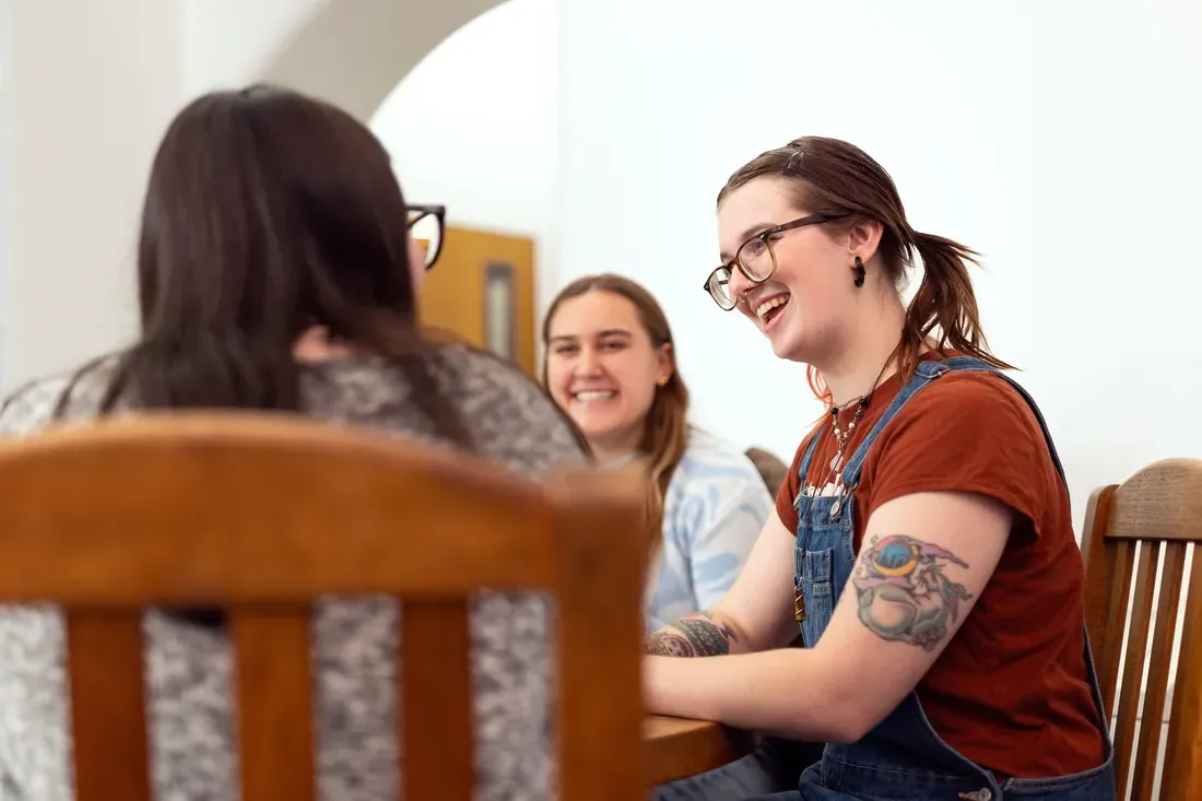 Three people sitting at a table.